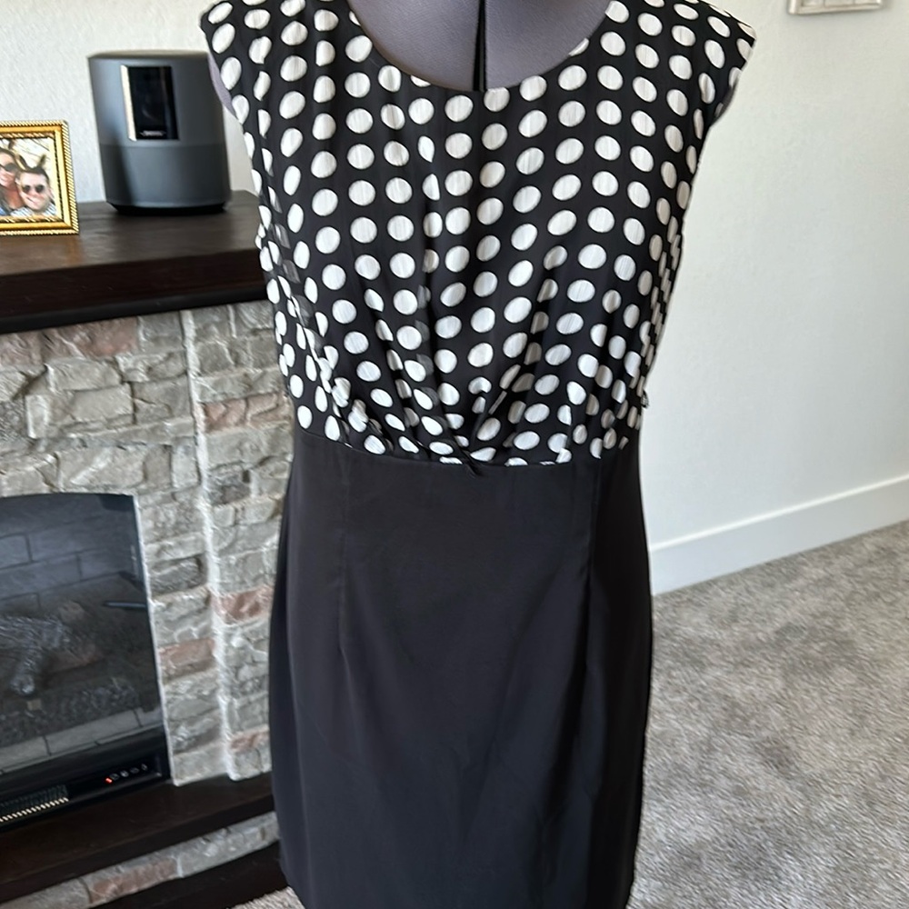 Women’s 14 top is black with white polka dots w/attached black skirt